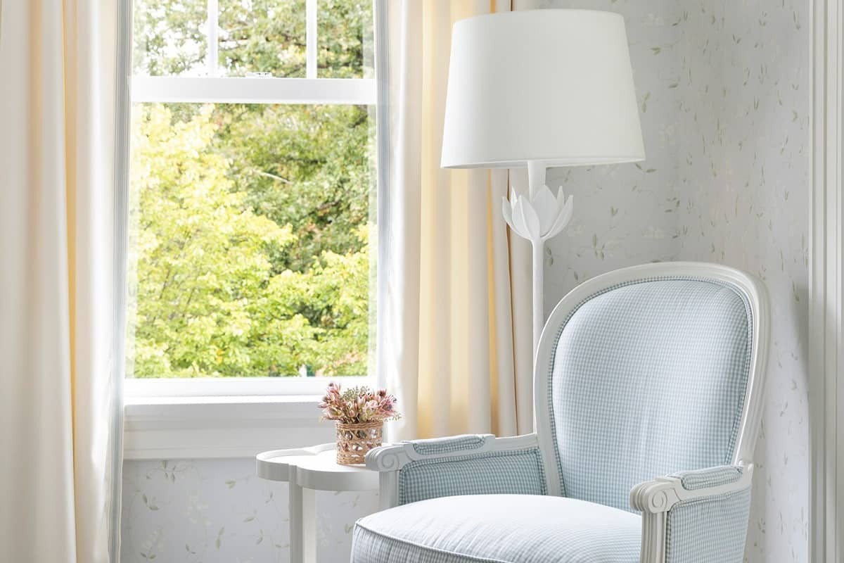 Provenance woven wood shades decorating a corner window 